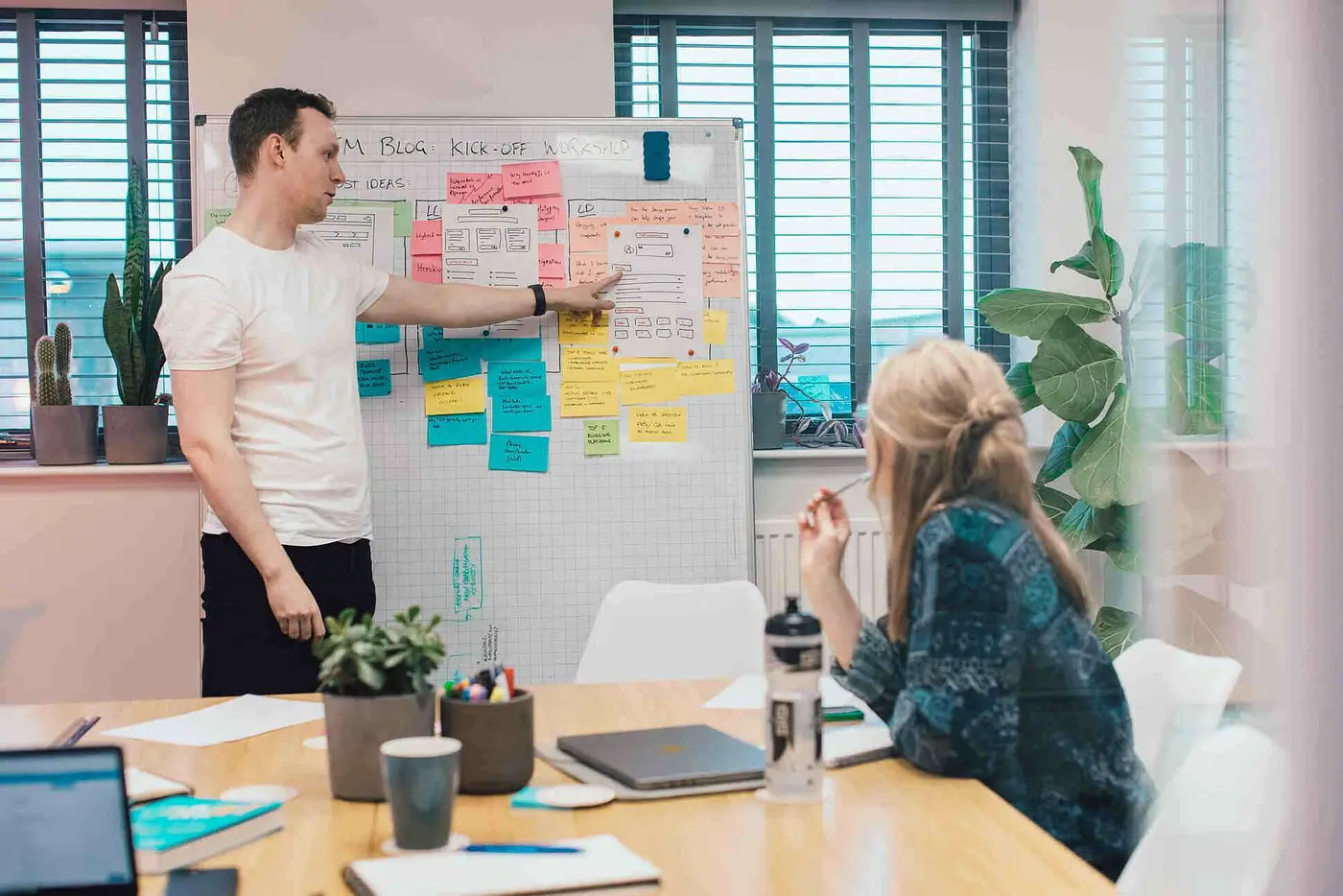Our Technical Director Rupert pointing at a mockup sketch on a whiteboard during a Discovery Workshop